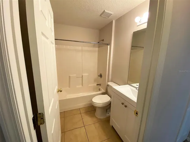 a bathroom with a shower toilet and sink