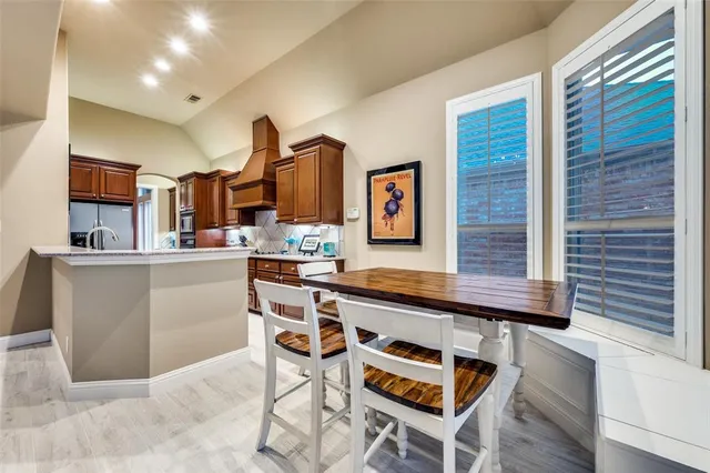 a kitchen with stainless steel appliances kitchen island granite countertop a sink and cabinets