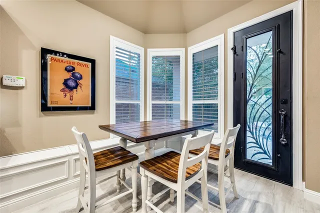 a view of a dining room with furniture large windows and wooden floor
