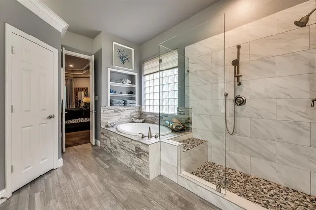 a bathroom with a granite countertop tub a sink and a shower