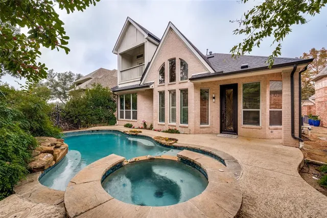 a view of a house with swimming pool and porch