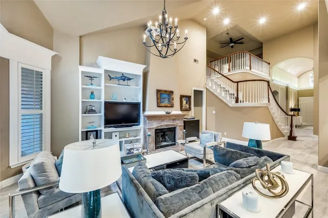 a living room with fireplace furniture and a flat screen tv
