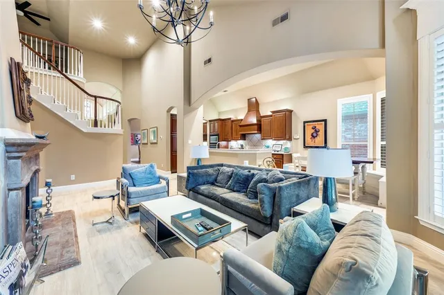 a living room with furniture and a chandelier