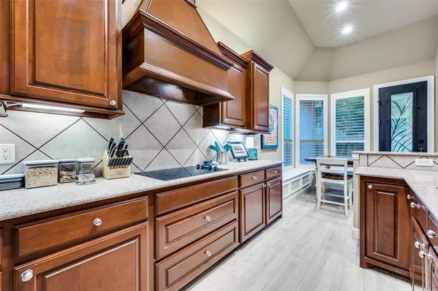 a kitchen with stainless steel appliances granite countertop a sink stove and cabinets