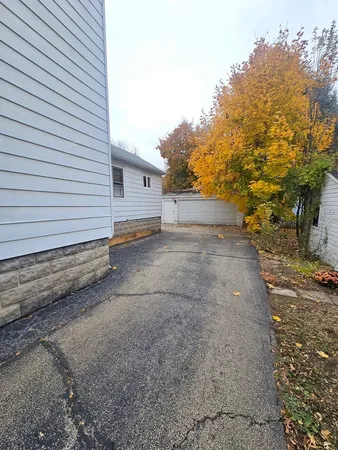 a view of a house with a yard and tree s