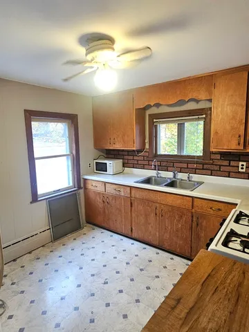 a kitchen with stainless steel appliances kitchen island granite countertop a sink and cabinets