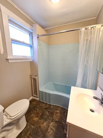 a bathroom with a sink a toilet and bathtub