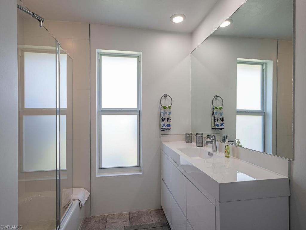 478 Torrey Pines Point Naples, FL 34113 - Photo 11 of 16 a bathroom with 2 sink and a mirror