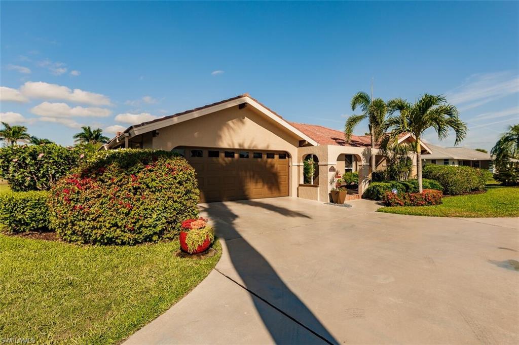 478 Torrey Pines Point Naples, FL 34113 - Photo 13 of 16 a front view of a house with a yard and garage