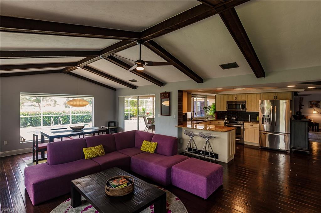 478 Torrey Pines Point Naples, FL 34113 - Photo 15 of 16 a living room with furniture and a large window