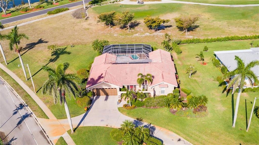 478 Torrey Pines Point Naples, FL 34113 - Photo 16 of 16 an aerial view of a swimming pool with a yard