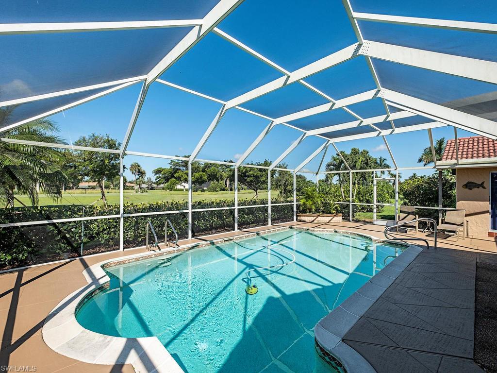 478 Torrey Pines Point Naples, FL 34113 - Photo 4 of 16 a view of a swimming pool with a patio
