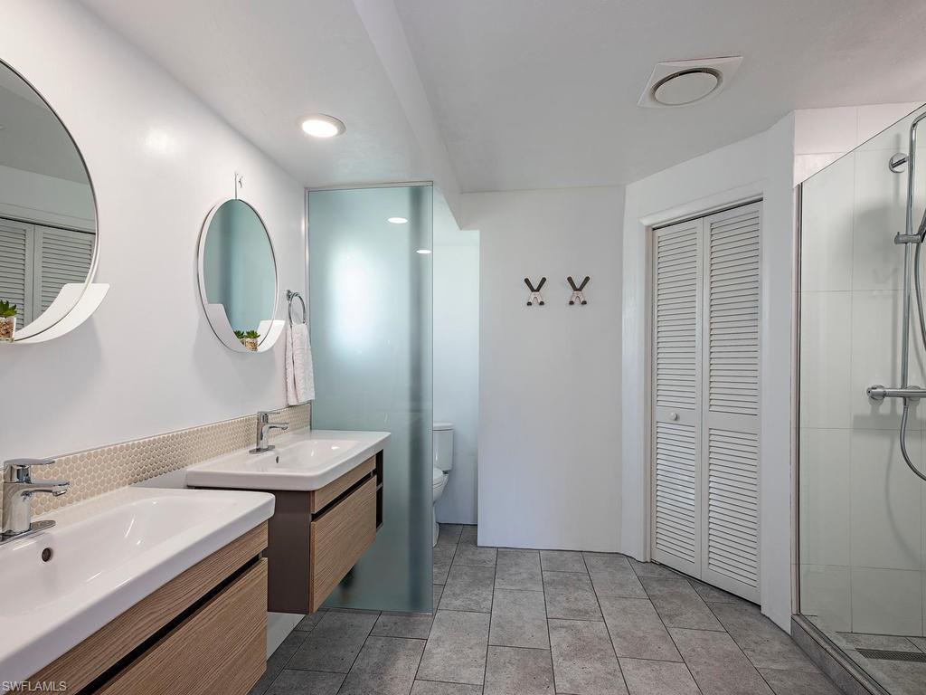 478 Torrey Pines Point Naples, FL 34113 - Photo 8 of 16 a spacious bathroom with a double vanity sink double and mirror
