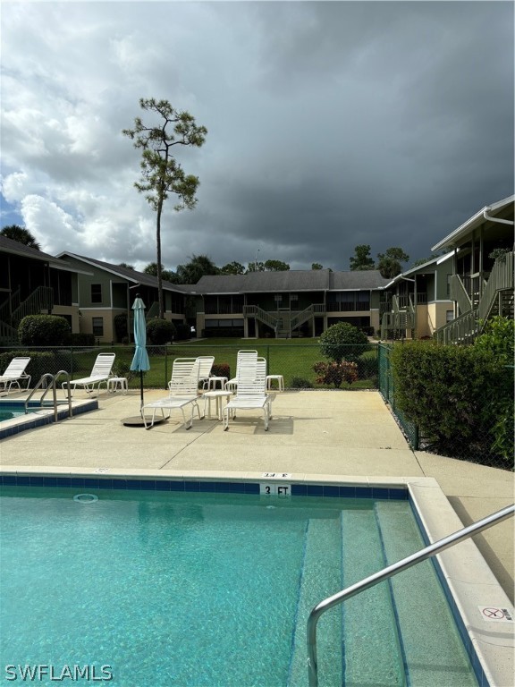5501 Rattlesnake Hammock Road, Unit 107 Naples, FL 34113 - Photo 9 of 23 a view of swimming pool with a patio and plants