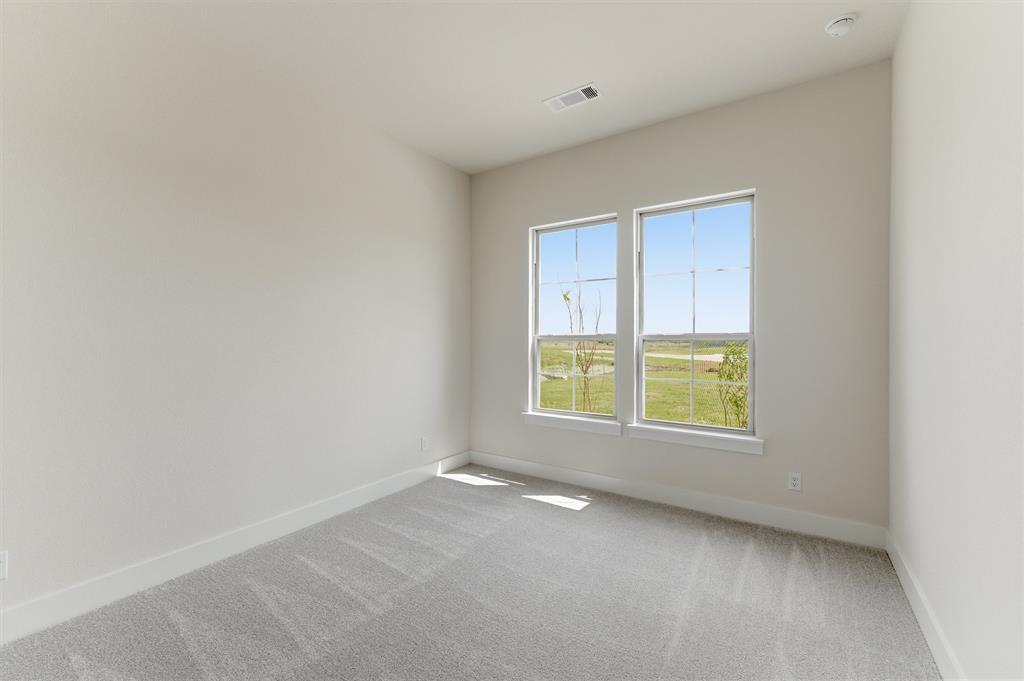 2433 Meteor Drive Krum, TX 76249 - Photo 6 of 29 Interior room featuring two large windows, light grey carpeting, white baseboards, light-colored walls, and a recessed ceiling light