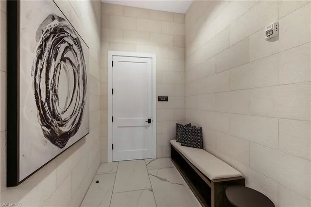 a bedroom with a bed and a chair