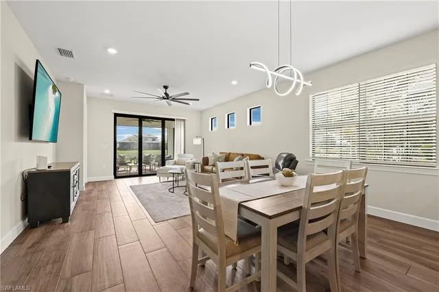 a view of a dining room with furniture window and wooden floor