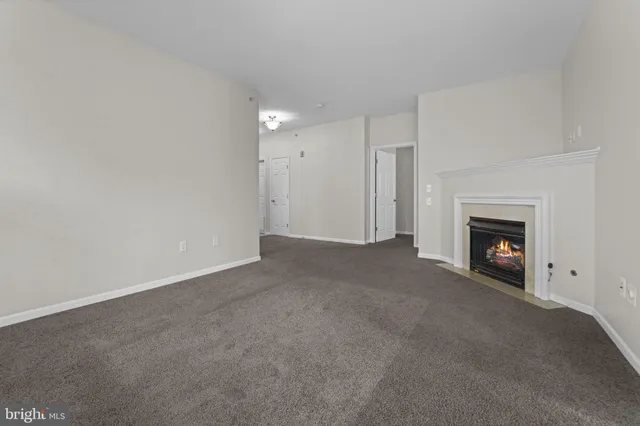 a view of empty room with a fireplace