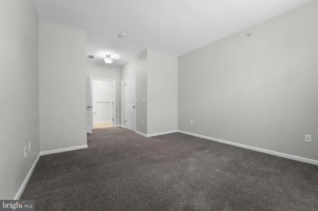 a view of an empty room with a ceiling fan