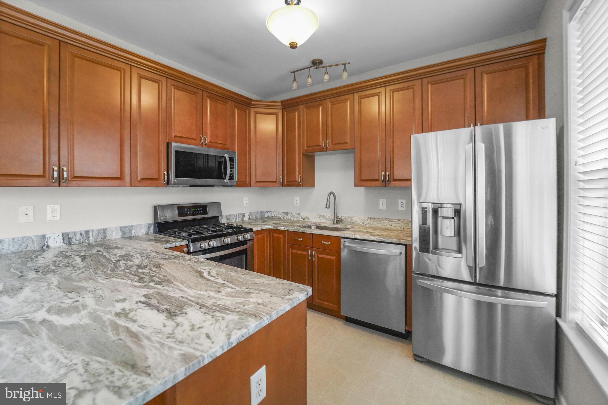 59 Kyle Way Ewing, NJ 08628 - Photo 23 of 35 a kitchen with stainless steel appliances granite countertop a refrigerator stove microwave and sink