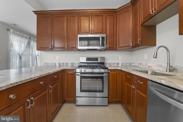 a kitchen with sink a microwave and cabinets
