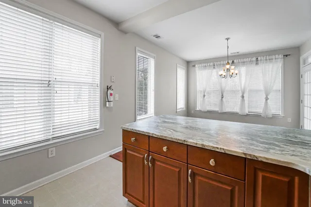 a bathroom with a granite countertop sink window and a mirror