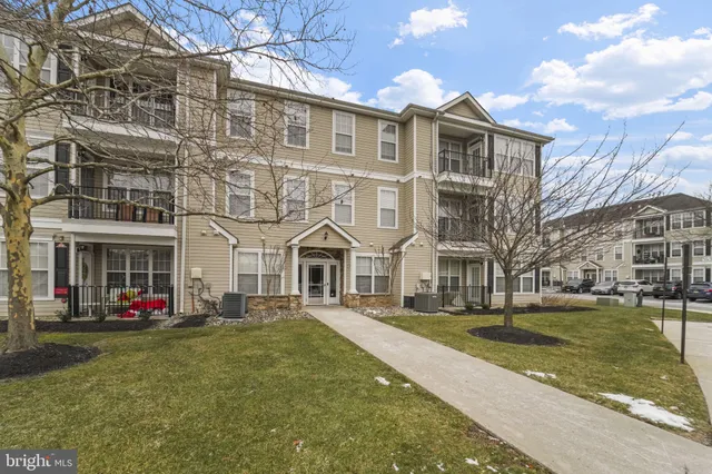 a front view of a residential apartment building with yard
