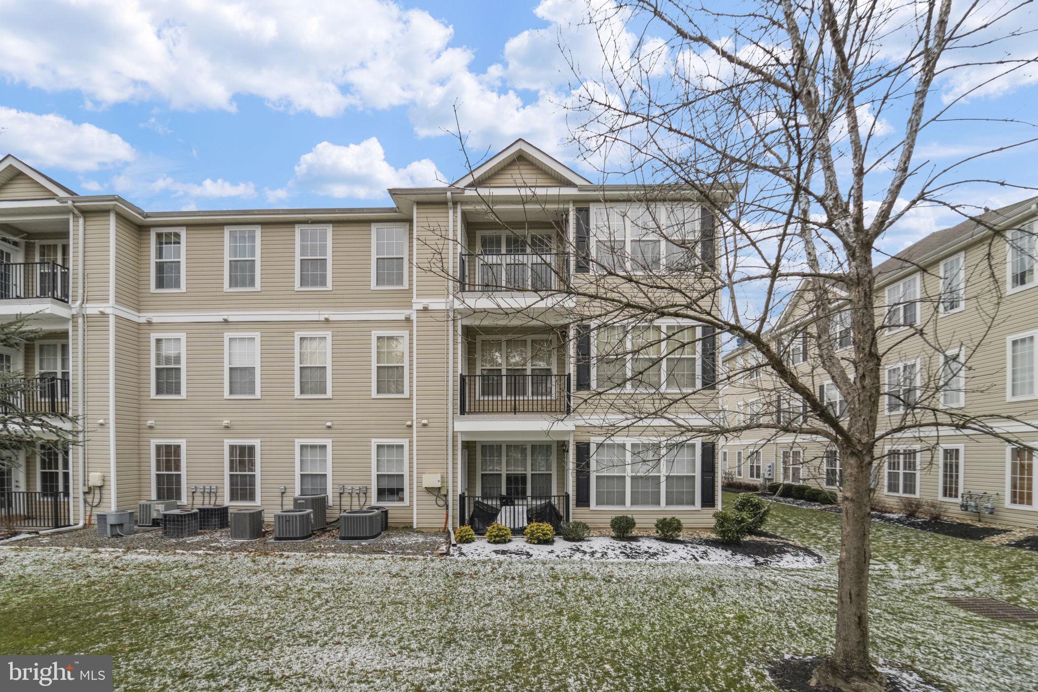 59 Kyle Way Ewing, NJ 08628 - Photo 33 of 35 a front view of residential houses with yard and trees