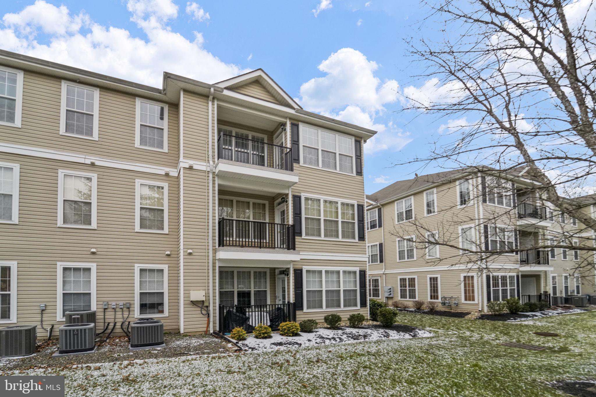 59 Kyle Way Ewing, NJ 08628 - Photo 34 of 35 a front view of a residential apartment building with a yard