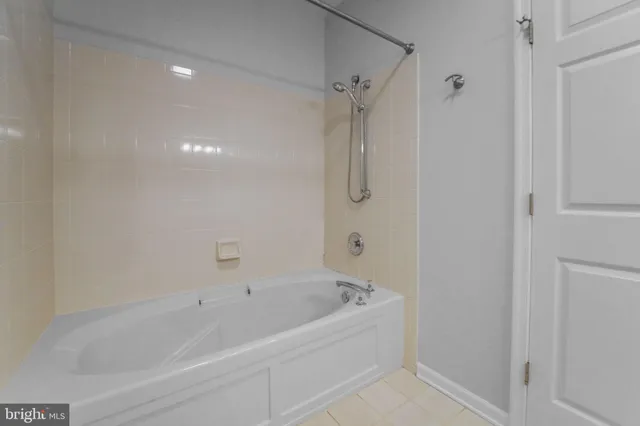 a white bath tub sitting next to a shower