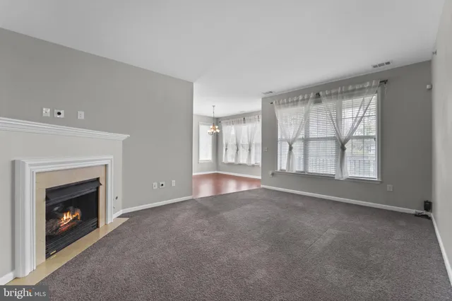 a view of an empty room with a fireplace