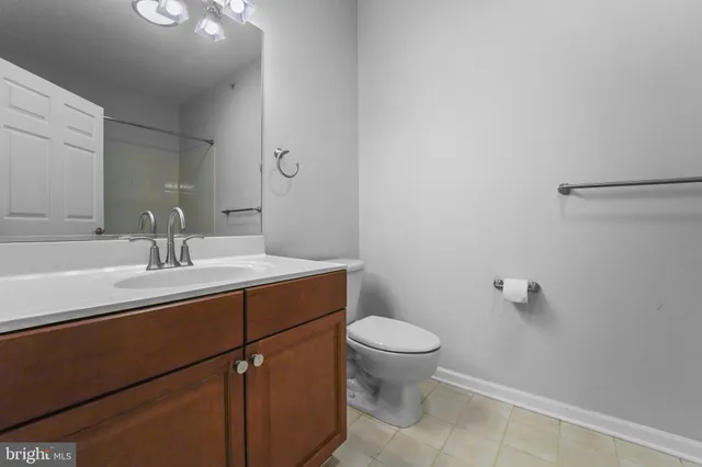a bathroom with a sink toilet and a mirror
