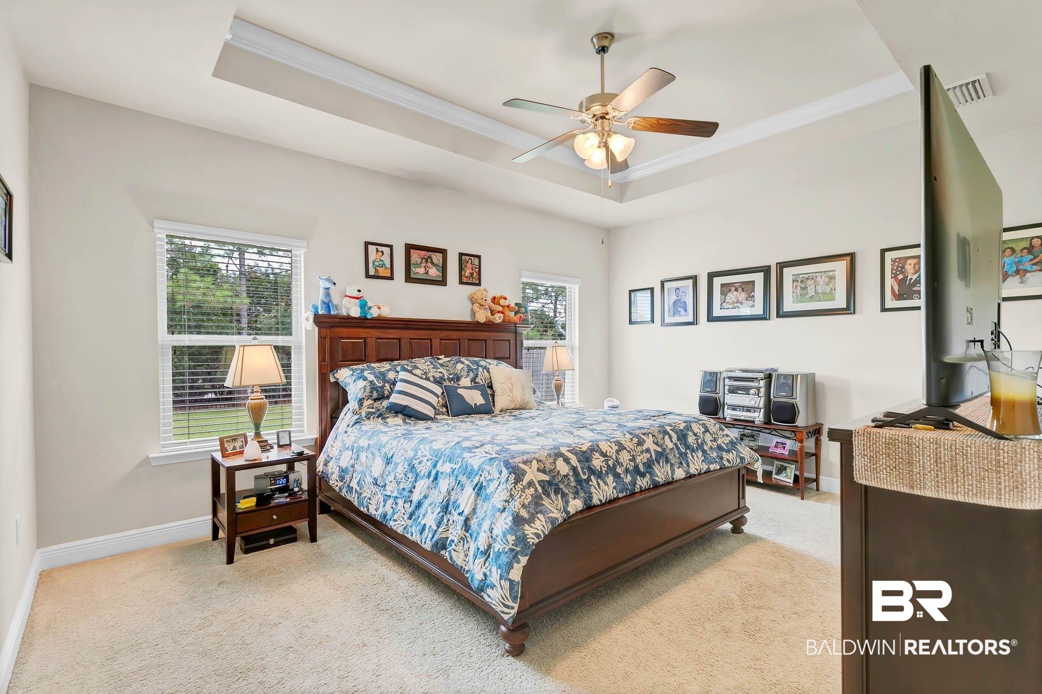 2049 Bourbon Street Foley, AL 36535 - Photo 20 of 56 Bedroom featuring light colored carpet, ornamental molding, a tray ceiling, and a ceiling fan