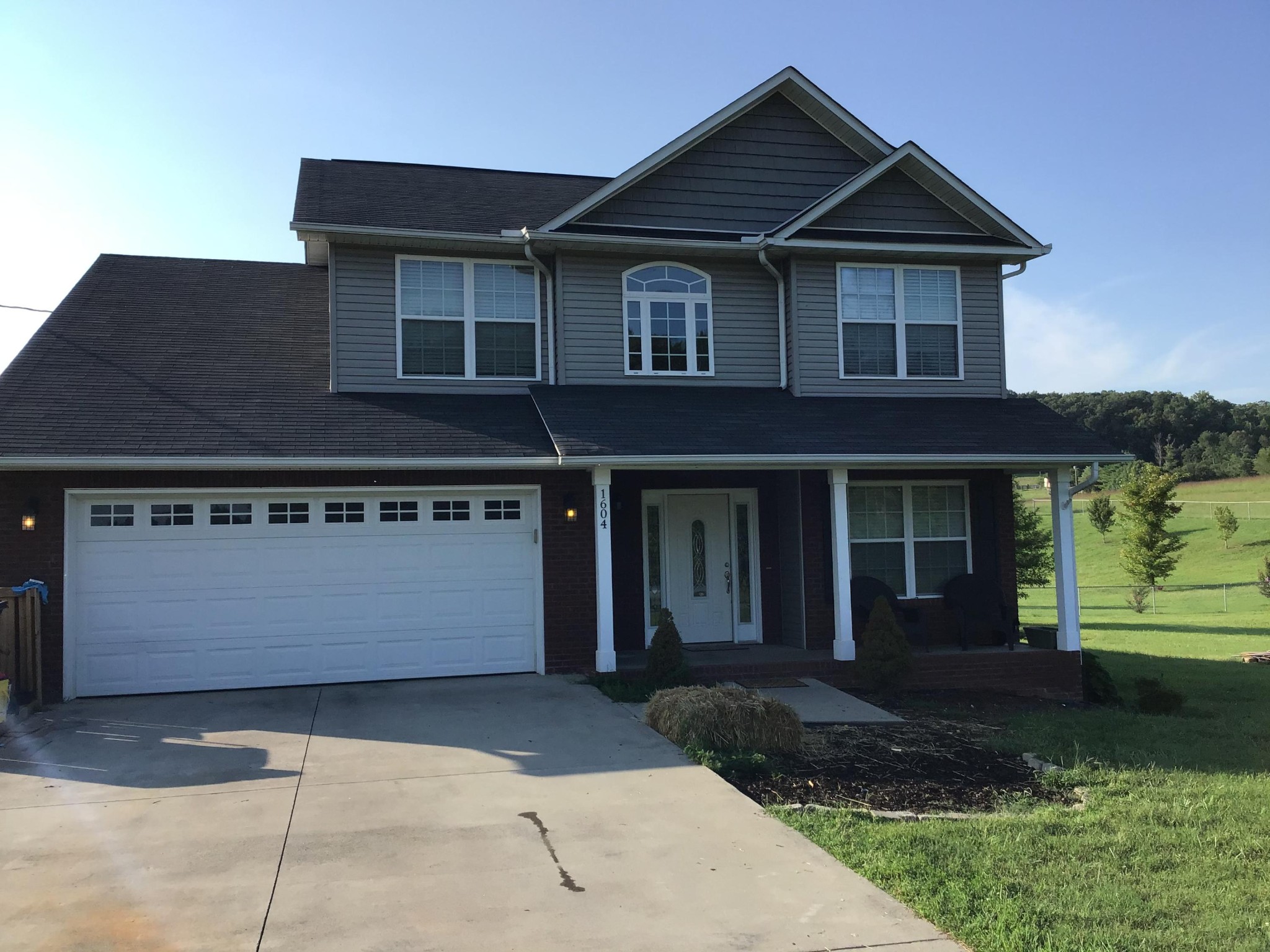 1604 Tilley Road Talbott, TN 37877 - Photo 1 of 31 a front view of a house with a yard and garage