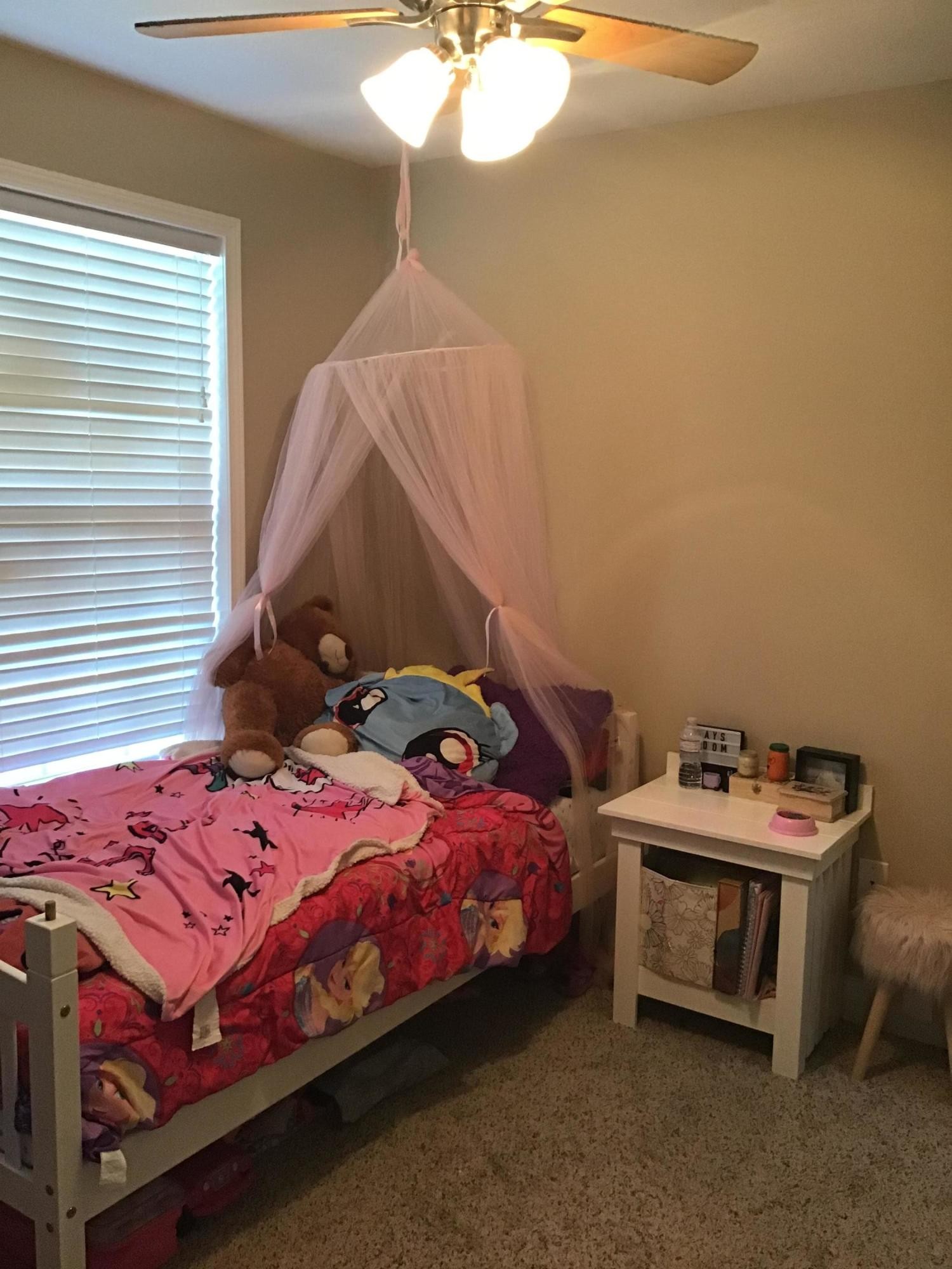 1604 Tilley Road Talbott, TN 37877 - Photo 22 of 31 a bedroom with a bed and a chandelier