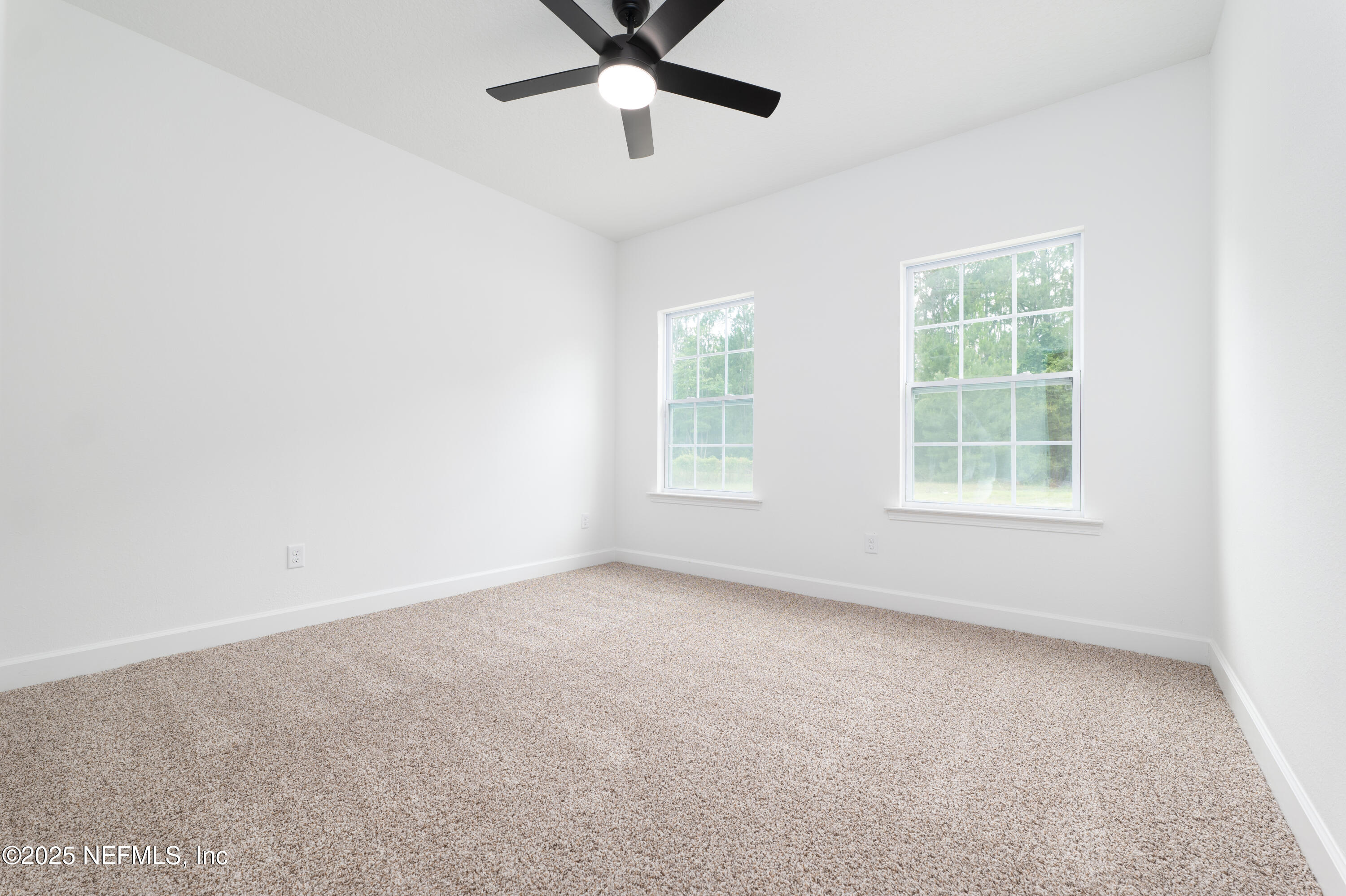 2410 Daisy Street Middleburg, FL 32068 - Photo 21 of 25 an empty room with windows and fan
