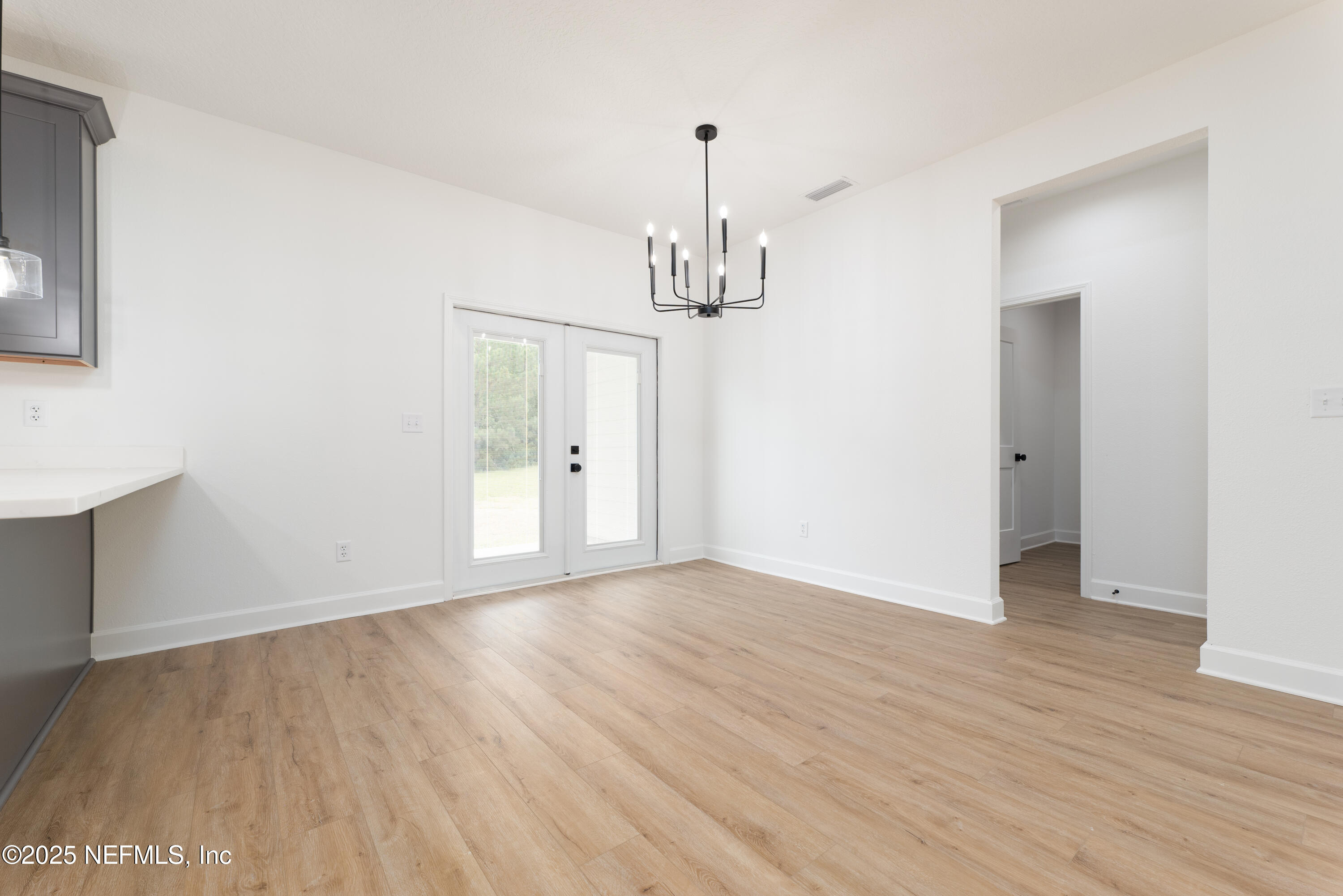 2410 Daisy Street Middleburg, FL 32068 - Photo 10 of 25 a view of empty room with wooden floor and window
