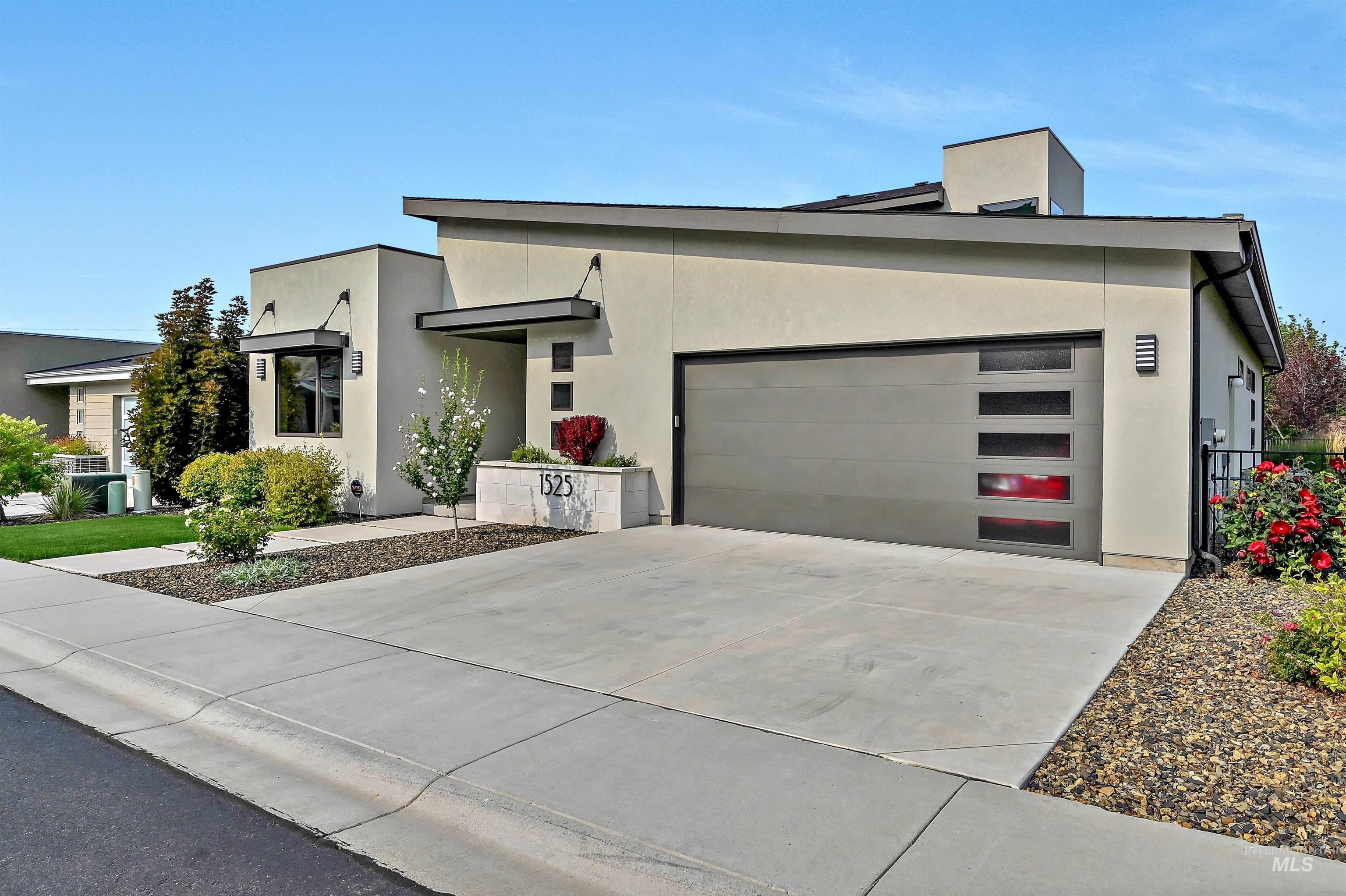 1525 South Boulder View Lane Boise, ID 83712 - Photo 2 of 34 Modern home with stucco siding, driveway, and an attached garage