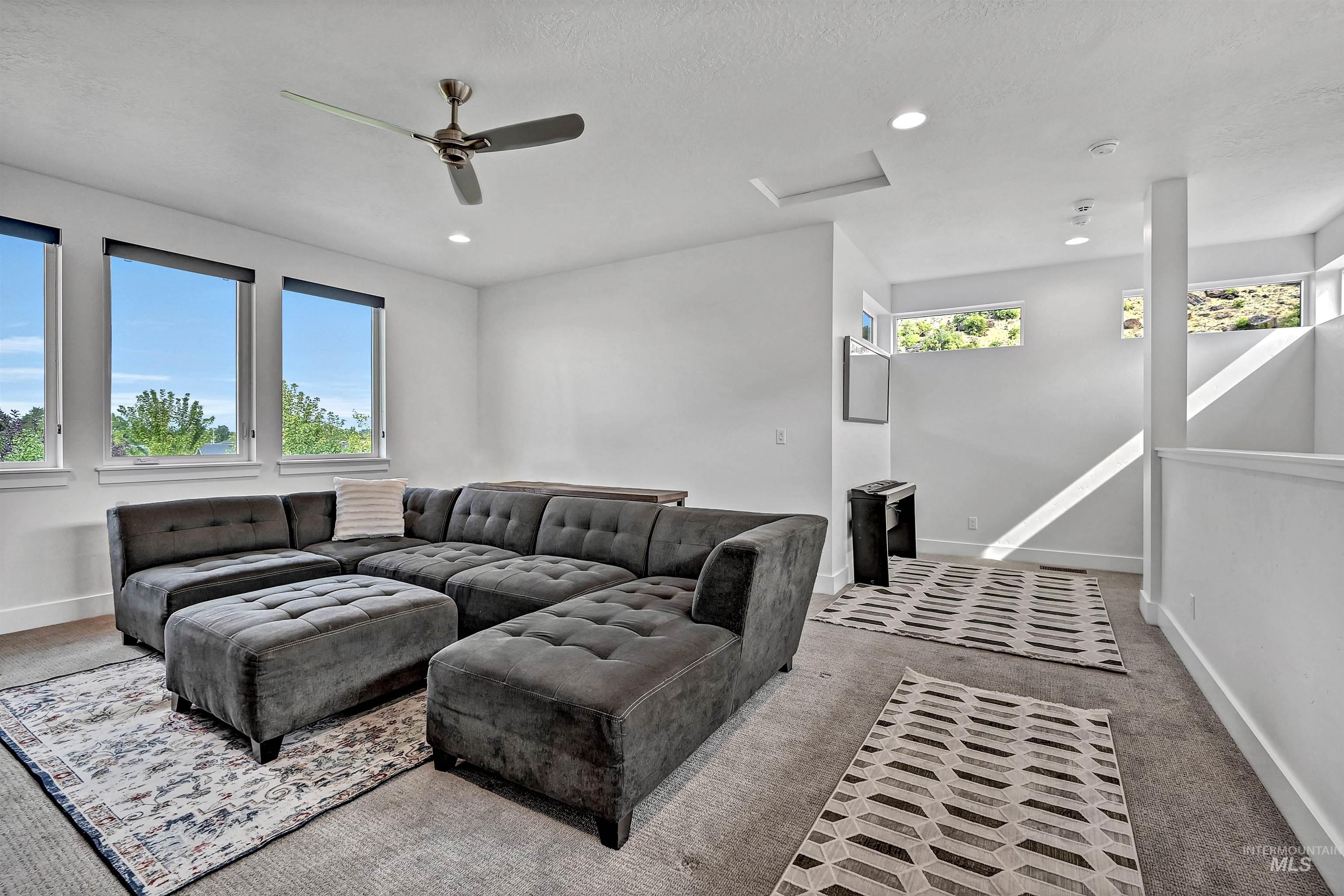 1525 South Boulder View Lane Boise, ID 83712 - Photo 20 of 34 Living room with carpet floors, attic access, a ceiling fan, recessed lighting, and a textured ceiling