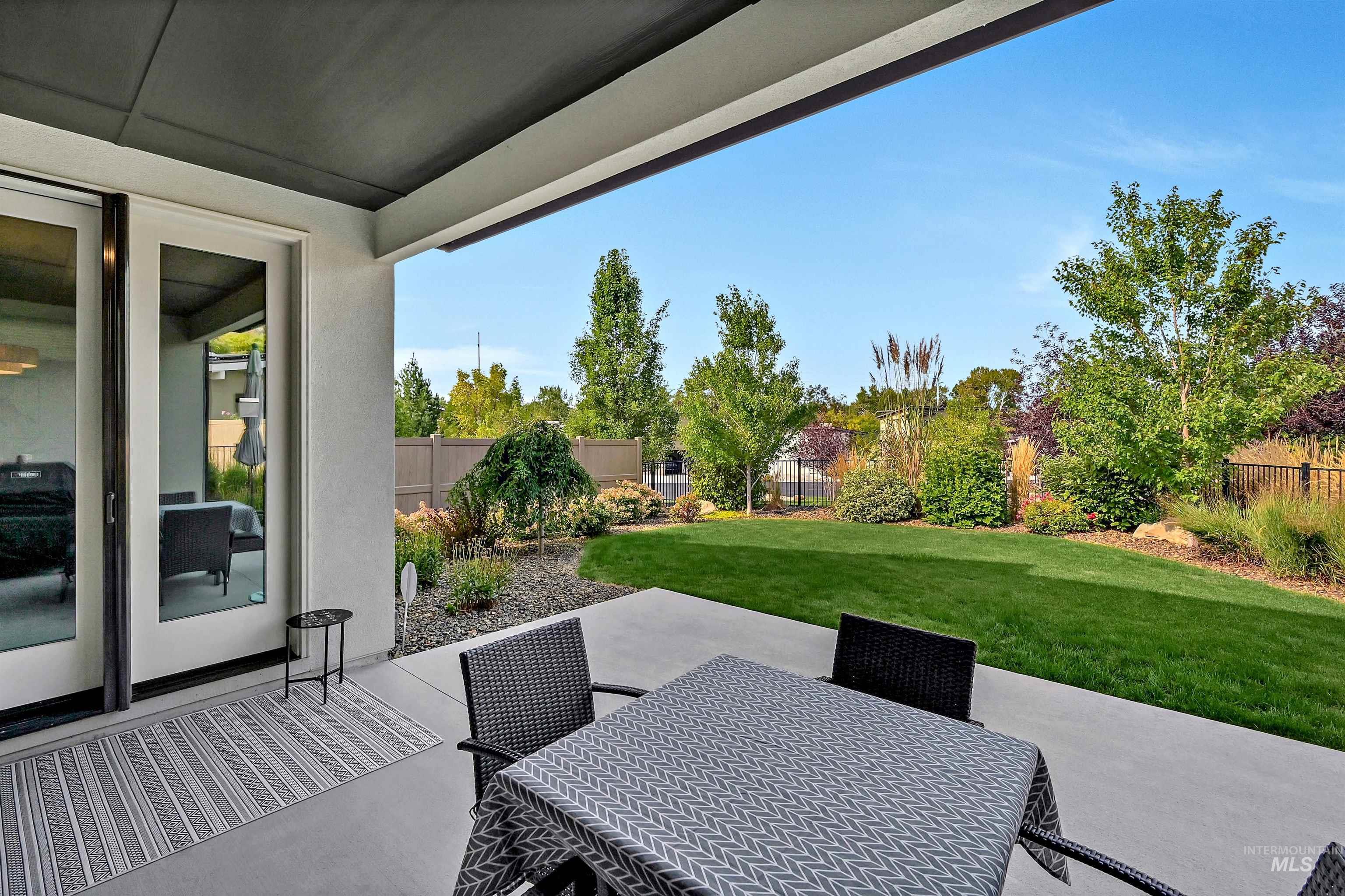1525 South Boulder View Lane Boise, ID 83712 - Photo 23 of 34 Fenced backyard with a patio and outdoor dining area