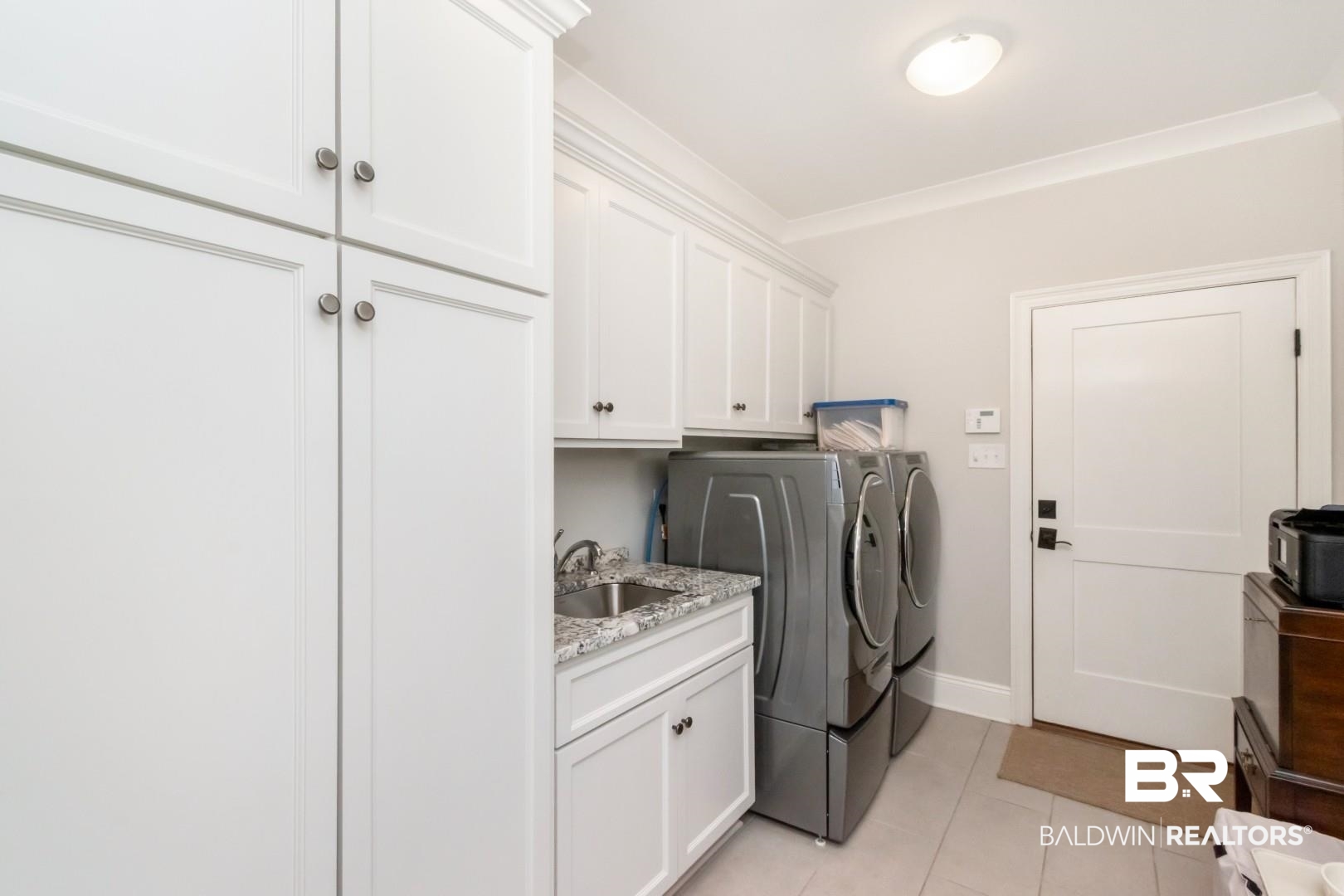 4404 Stein Street Mobile, AL 36608 - Photo 42 of 50 Laundry area featuring light tile patterned floors, cabinet space, washer and clothes dryer, and ornamental molding