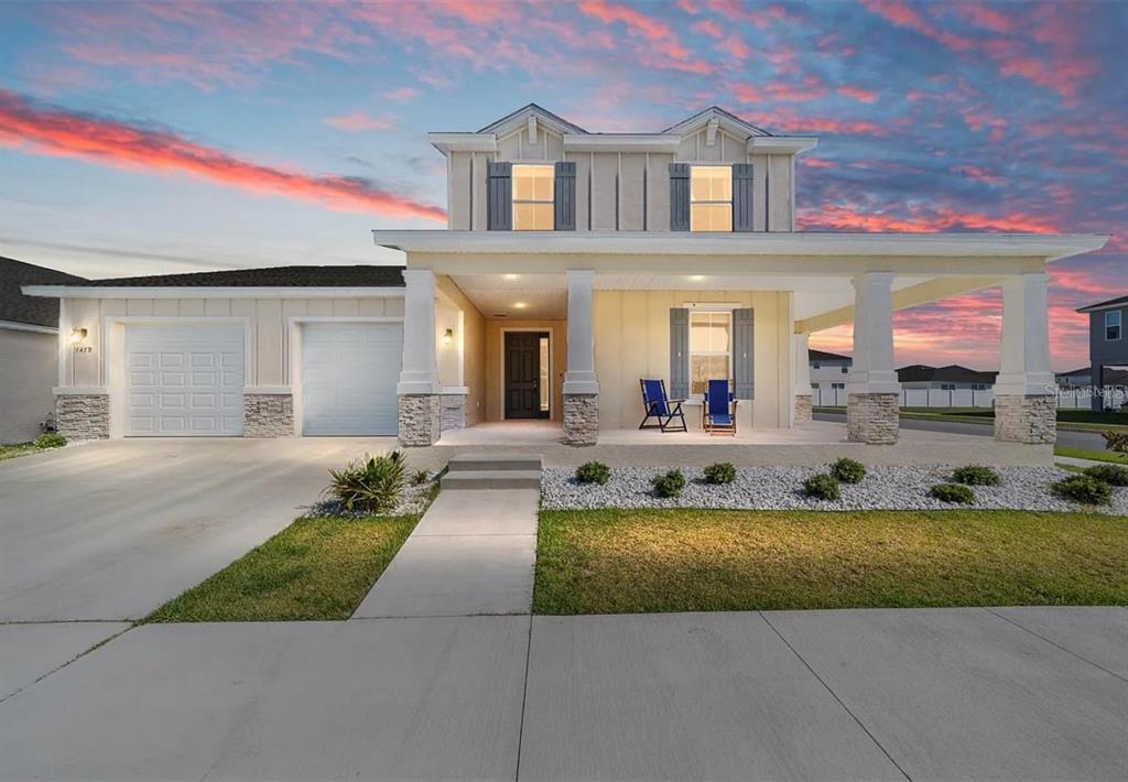 a view of a house with a swimming pool and a yard