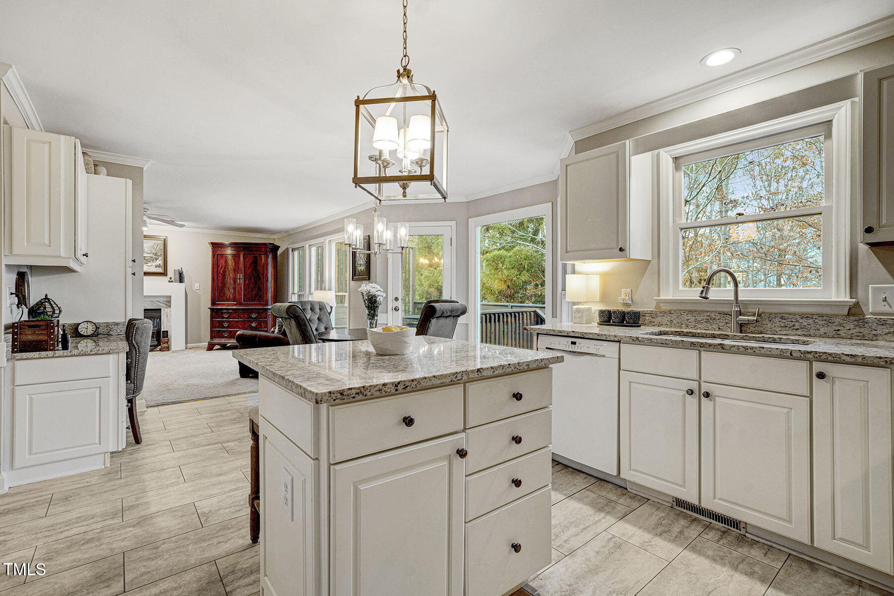 113 Waterfall Court Cary, NC 27513 - Photo 11 of 30 a open kitchen with granite countertop a stove a sink a dining table and chairs with wooden floor