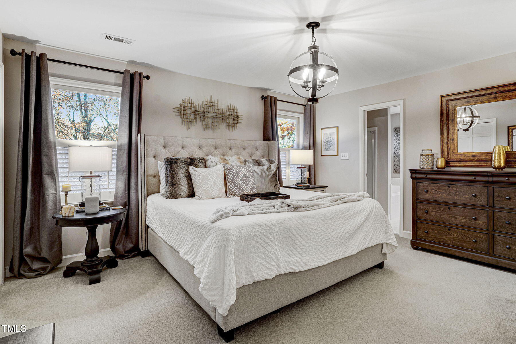 113 Waterfall Court Cary, NC 27513 - Photo 17 of 30 a bedroom with a bed and a chandelier