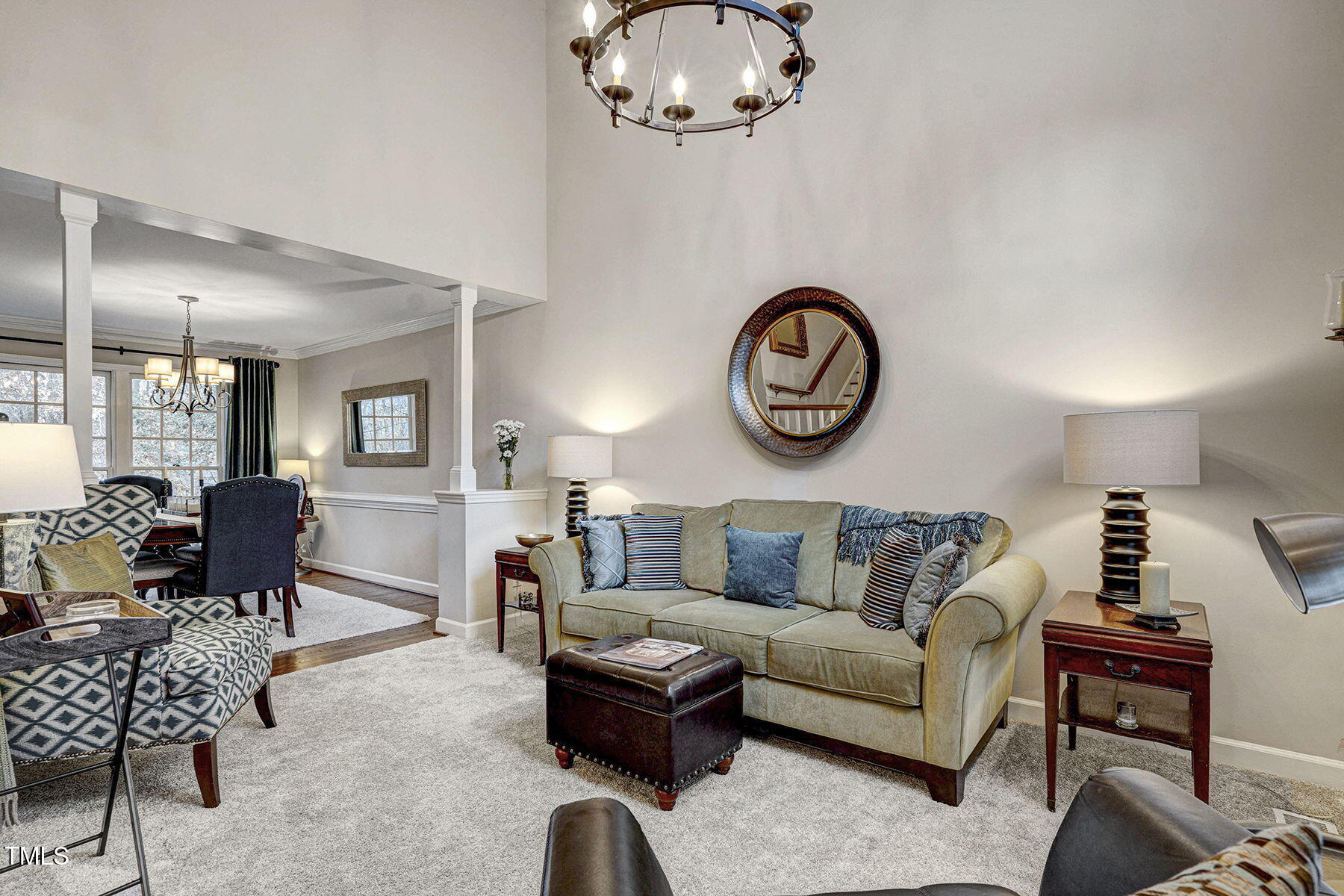 113 Waterfall Court Cary, NC 27513 - Photo 4 of 30 a living room with furniture a dining table and a chandelier