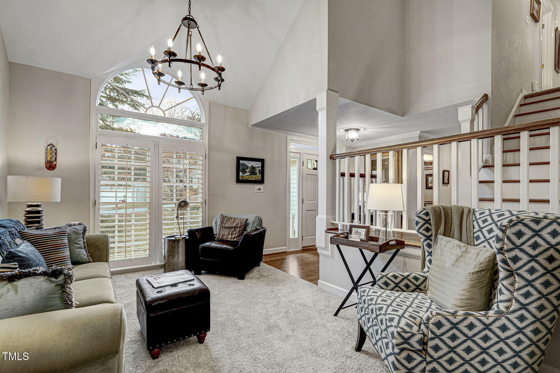 113 Waterfall Court Cary, NC 27513 - Photo 6 of 30 a living room with furniture a dining table and a chandelier