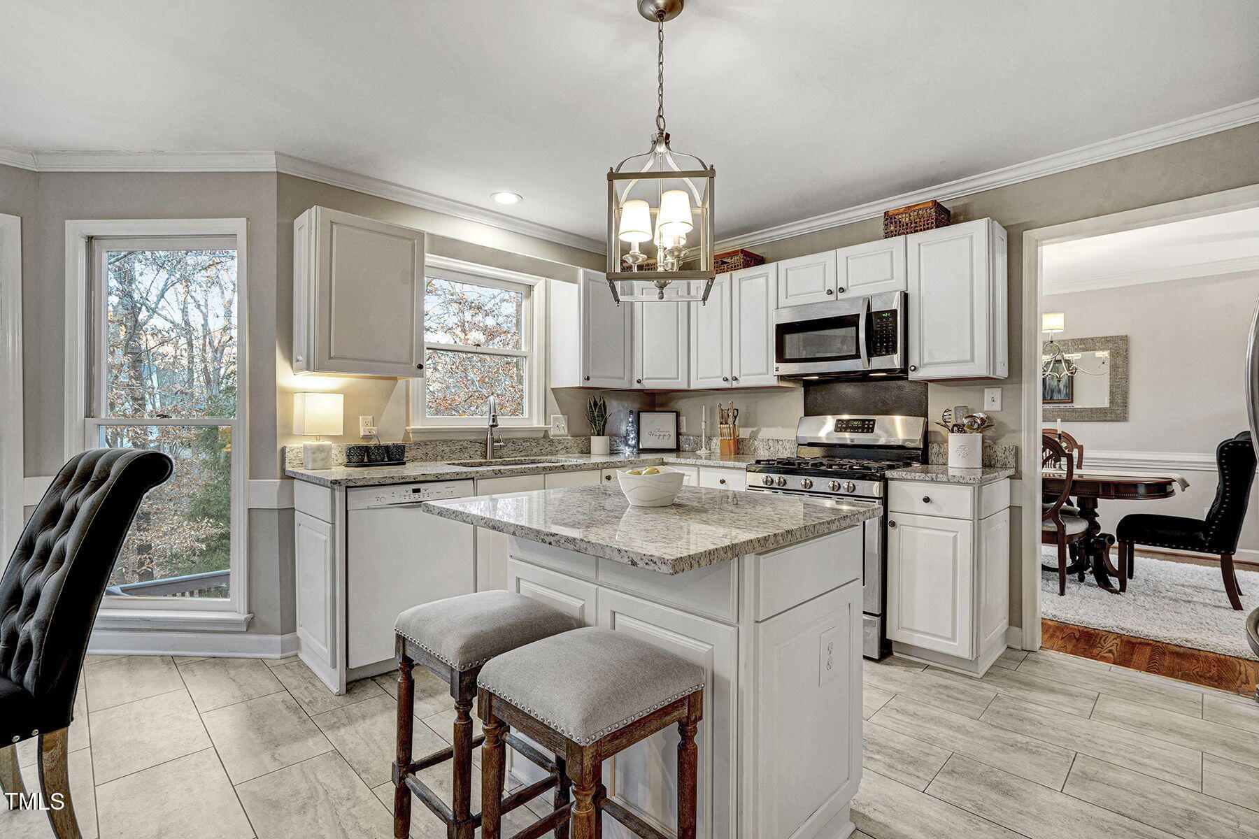 113 Waterfall Court Cary, NC 27513 - Photo 9 of 30 a kitchen with kitchen island granite countertop a sink window and stainless steel appliances