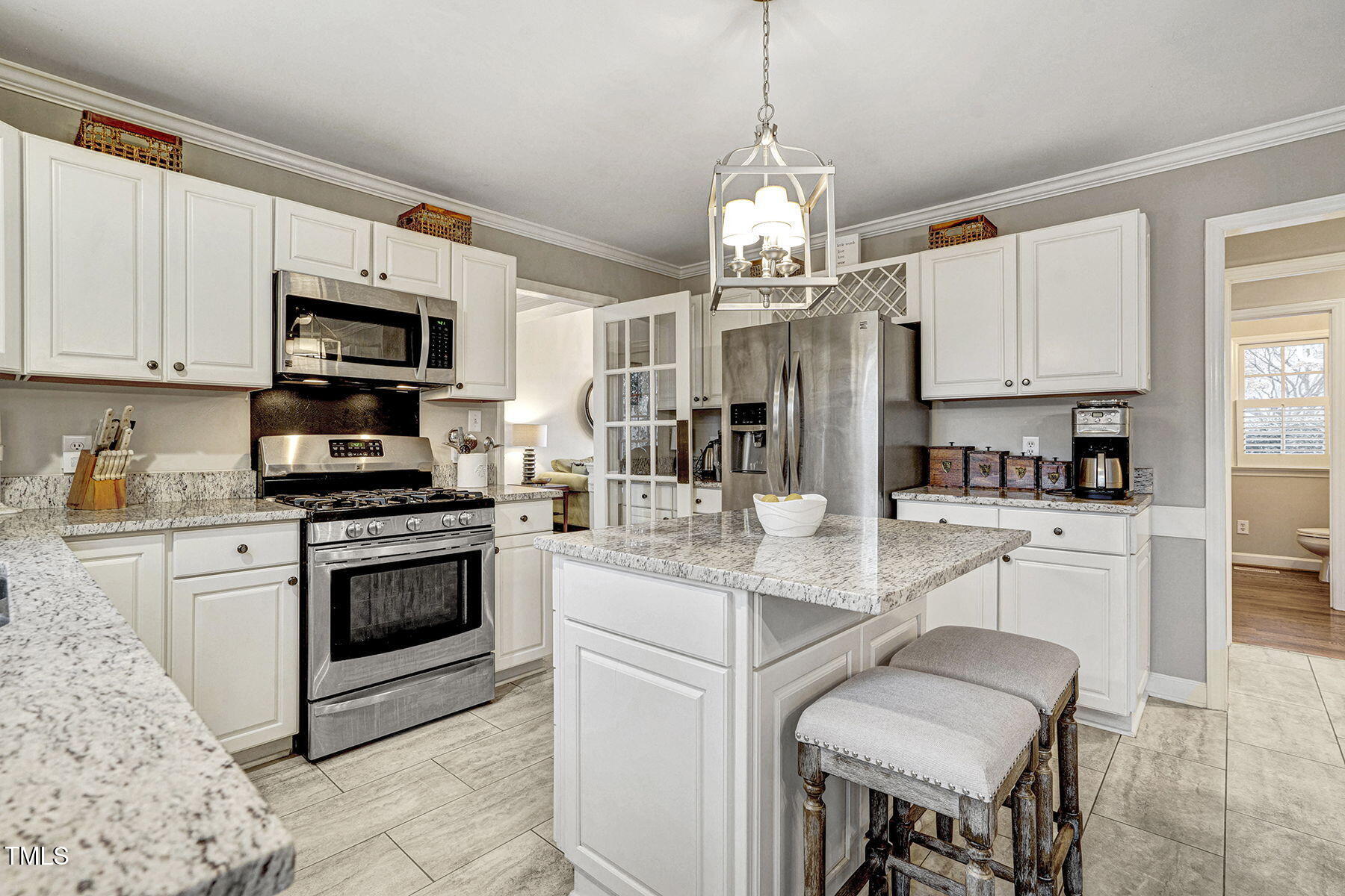 113 Waterfall Court Cary, NC 27513 - Photo 10 of 30 a kitchen with stainless steel appliances granite countertop a stove refrigerator and cabinets