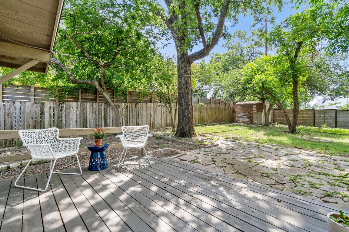 2116 Glendale Place Austin, TX 78704 - Photo 23 of 24 a view of a patio with table and chairs with wooden fence and trees
