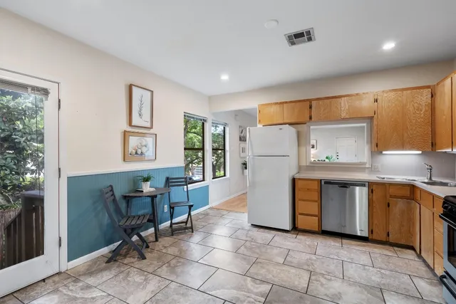 a kitchen with refrigerator and cabinets